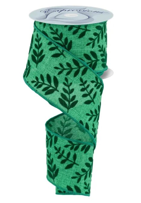 A roll of green and black leaf-patterned ribbon.