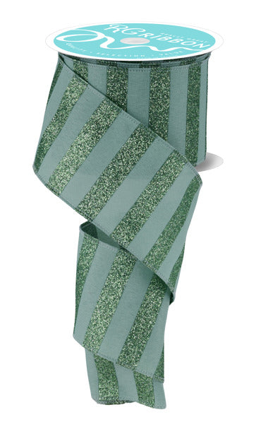 A roll of green and silver striped ribbon with a white label on top.