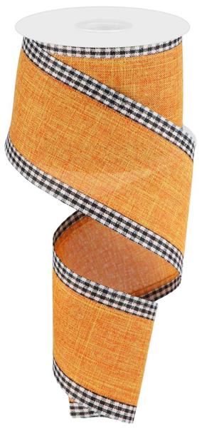 a roll of orange and black checkered ribbon