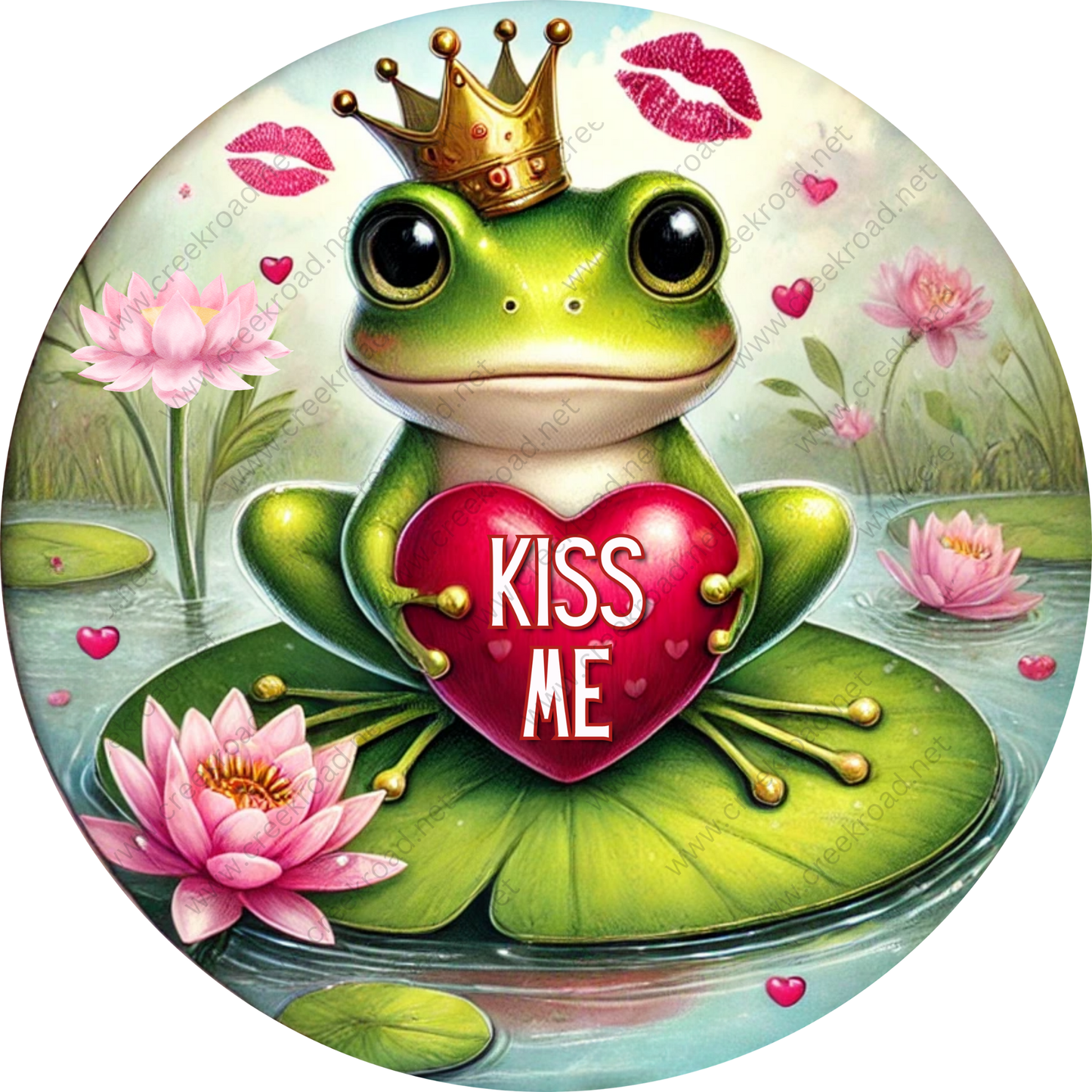 A green frog wearing a crown and holding a heart with the words "KISS ME" is surrounded by pink flowers and lily pads in a pond setting.