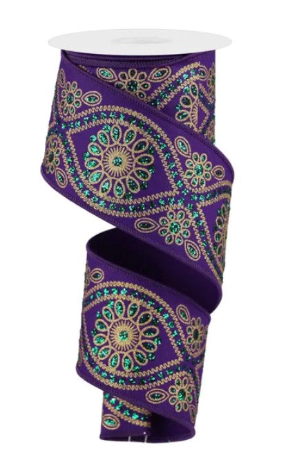 a purple ribbon with a gold and green floral pattern.