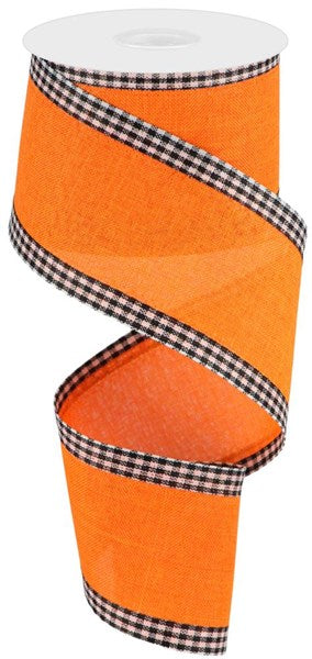 a roll of orange ribbon with a check pattern on it