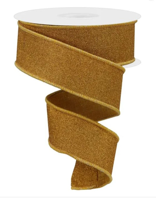 a gold-colored, shiny ribbon that is coiled and twisted in a spiral pattern.