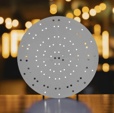 a circular object with small holes or dots arranged in a circular pattern, creating a visually striking and abstract design.