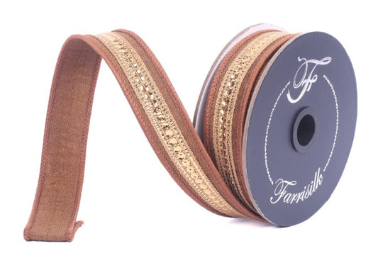 A spool of brown and gold ribbon with a decorative pattern, sitting on a white background.