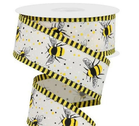 A roll of decorative ribbon with a repeating pattern of yellow and black bees on a white background.