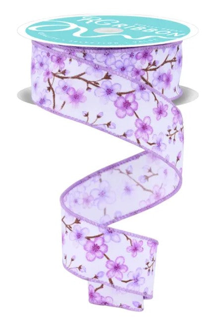 A roll of purple floral ribbon with a white background.