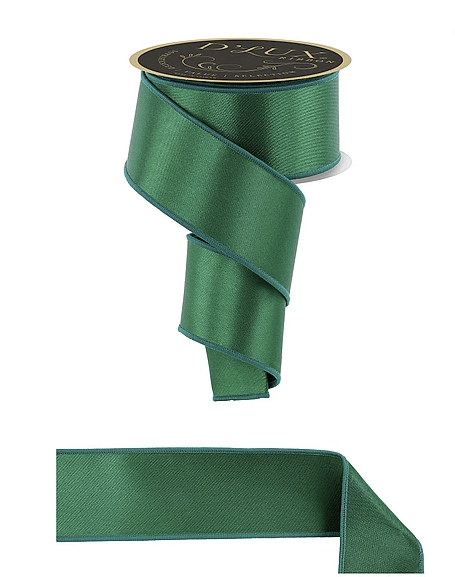 a green satin ribbon with a gold label, and a smaller piece of the same ribbon.