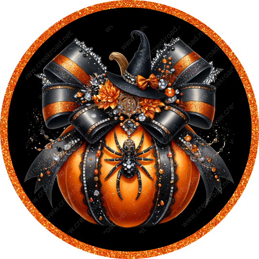a pumpkin with a witch hat on top of it