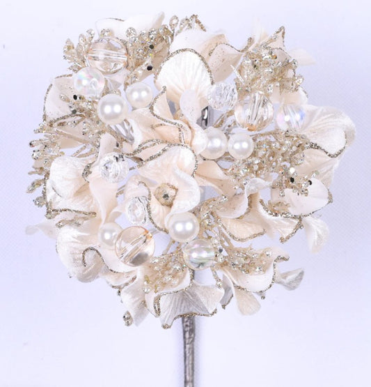 A beautiful bouquet of white flowers adorned with silver and crystal embellishments, including pearls and crystals, creating a stunning and elegant floral arrangement.