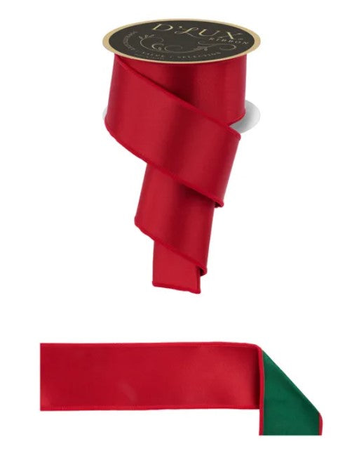 a red ribbon with a green trim, and it is attached to a spool of the same red ribbon.
