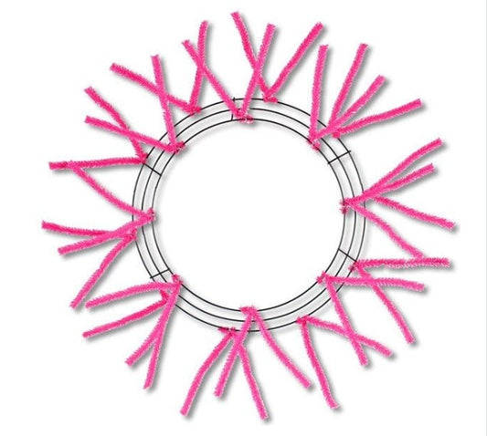 a circular frame made of pink pipe cleaners, with the pipe cleaners arranged in a circular pattern around the frame.