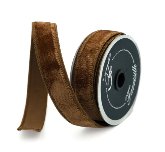 A roll of brown velvet ribbon with a black label.