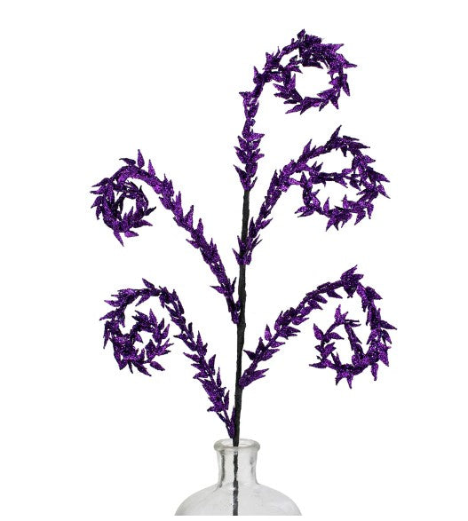 a purple flower in a clear vase on a white background