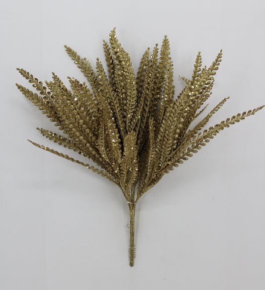 A cluster of golden fern-like leaves or branches against a white background.