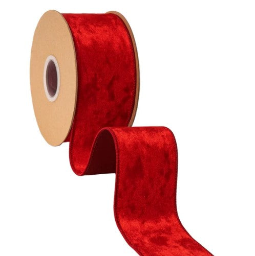 A roll of red velvet ribbon with a gold-colored spool.