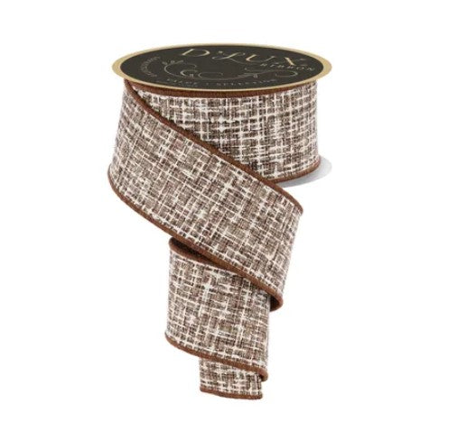 A brown and white tweed ribbon with a gold label on top.