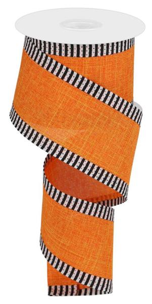 a roll of orange ribbon with black and white stripes