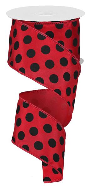 a roll of red and black polka dot ribbon