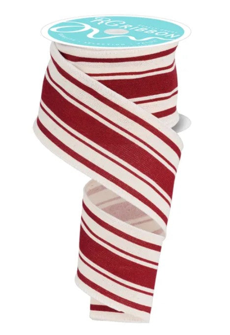 A roll of red and white striped ribbon with a turquoise label.