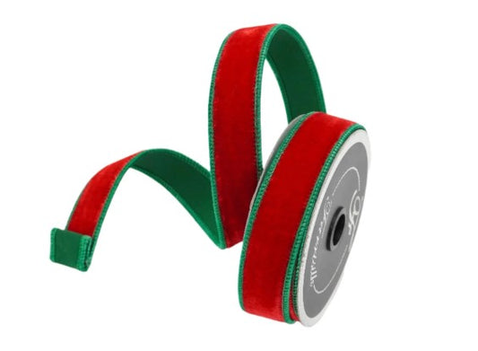 A spool of red and green velvet ribbon is shown against a white background.