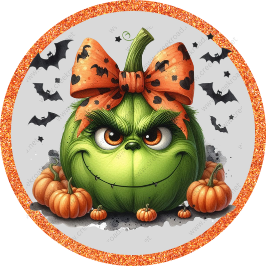 a green pumpkin with a bow on it's head