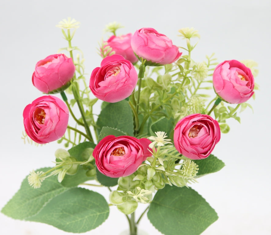 a vase filled with pink flowers on top of a table