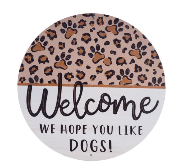 A round sign with a leopard print pattern and the text "Welcome We hope you like dogs!"
