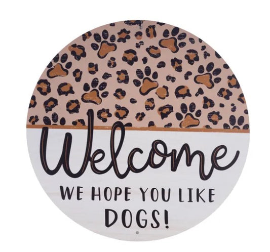 A round sign with a leopard print pattern and the text "Welcome We hope you like dogs!"