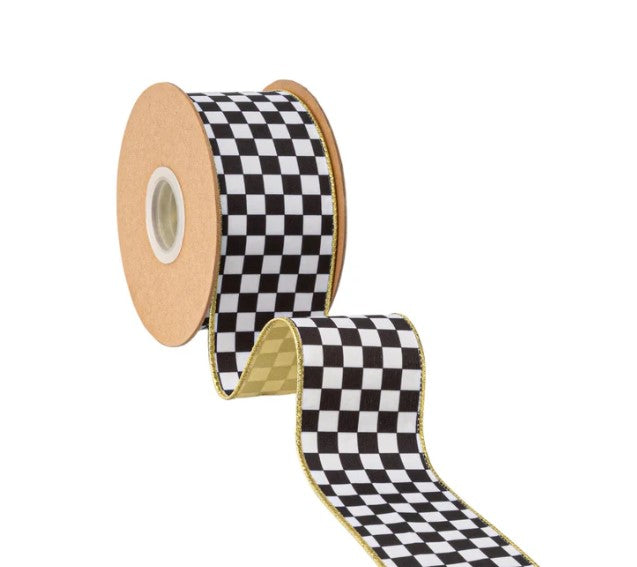 A spool of checkered black and white ribbon is shown against a white background.