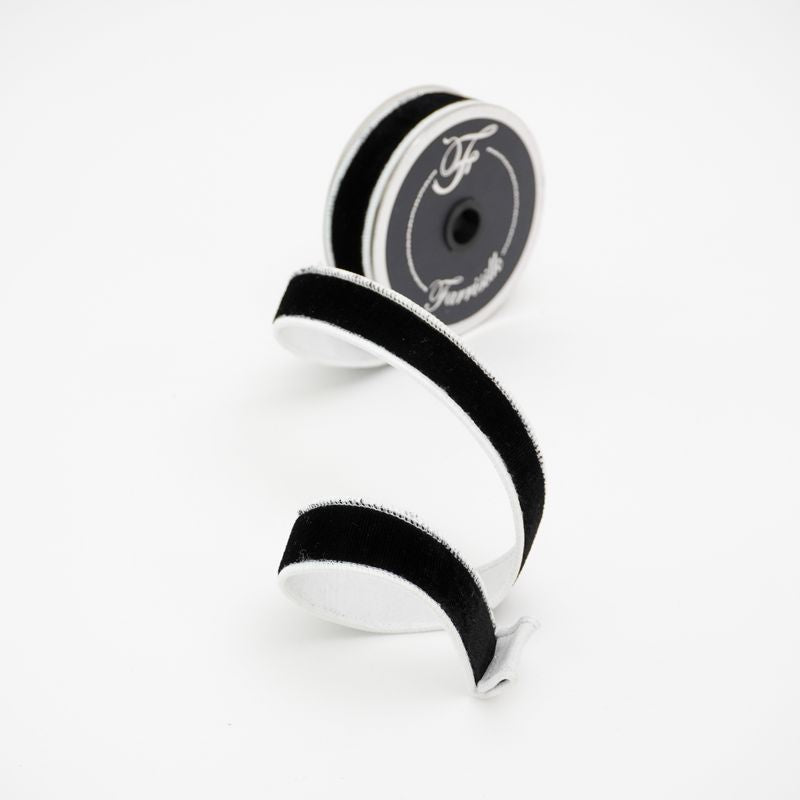 a pair of black and white ribbon on a white background