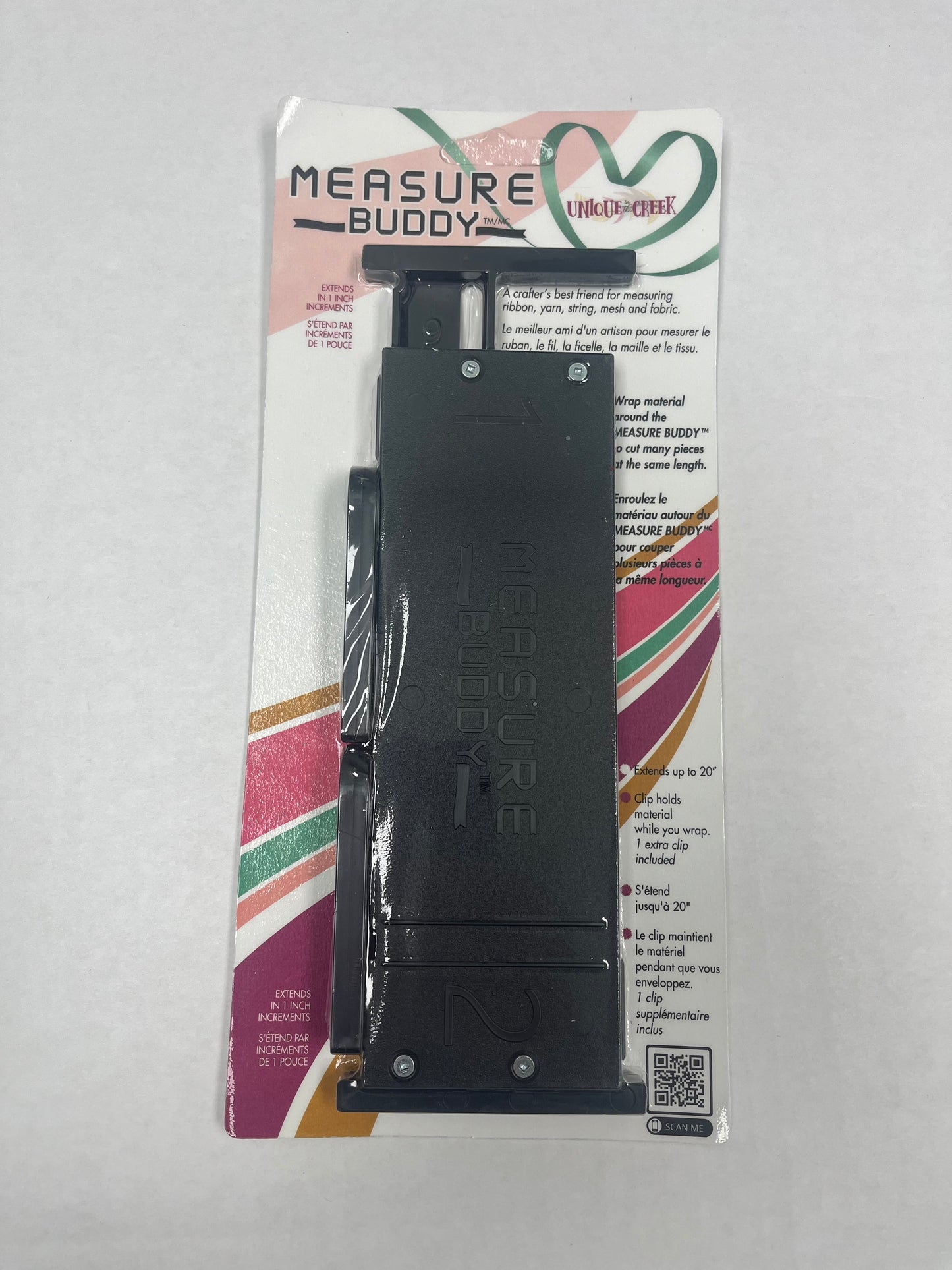 a black measuring tool, specifically a "MEasure Buddy", which is a flexible measuring device designed for fabric or other materials.
