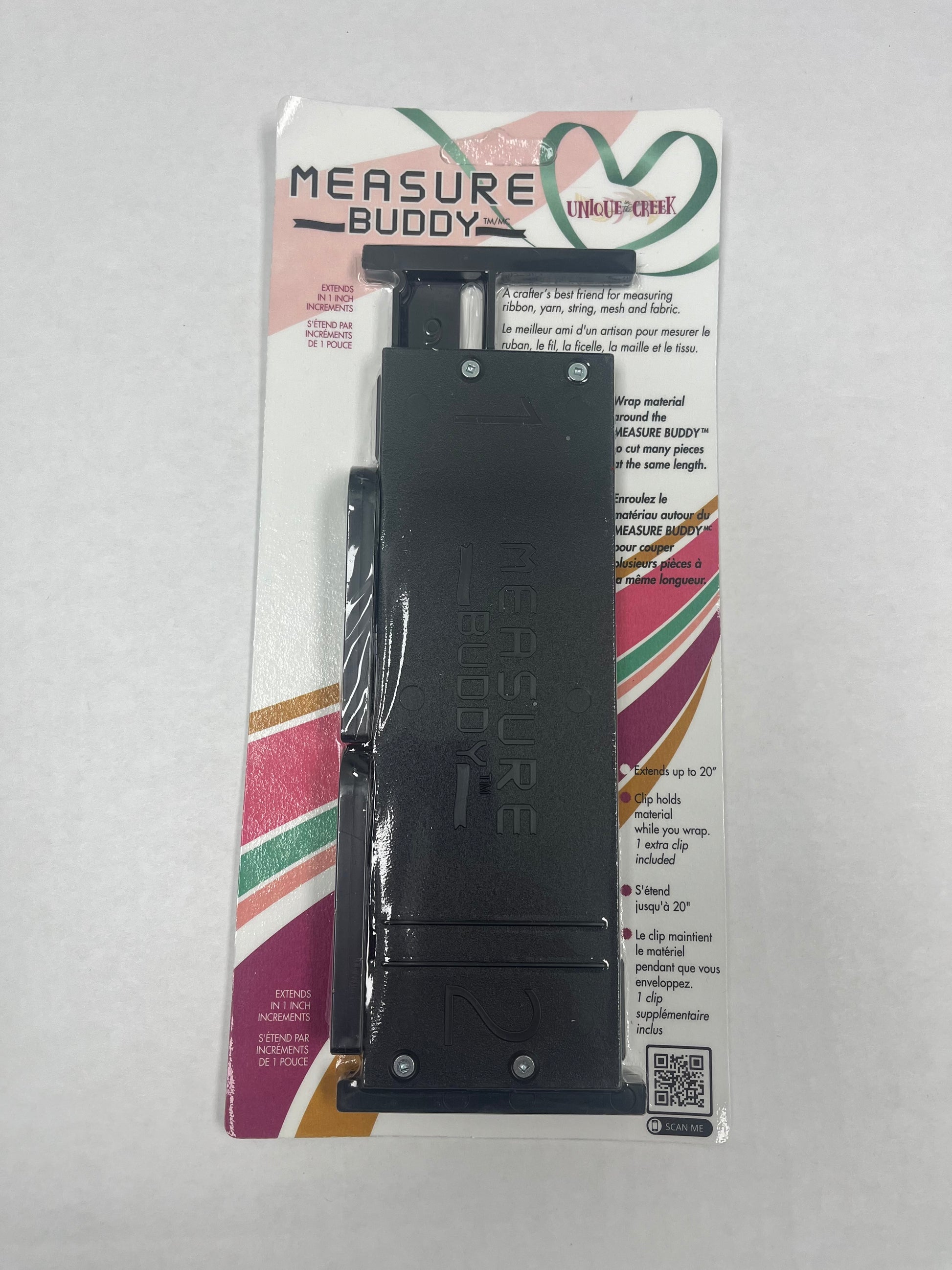 a black measuring tool, specifically a "MEasure Buddy", which is a flexible measuring device designed for fabric or other materials.