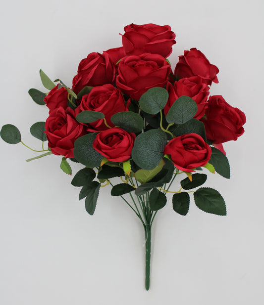 A bouquet of red roses with green leaves, arranged in a visually appealing manner.