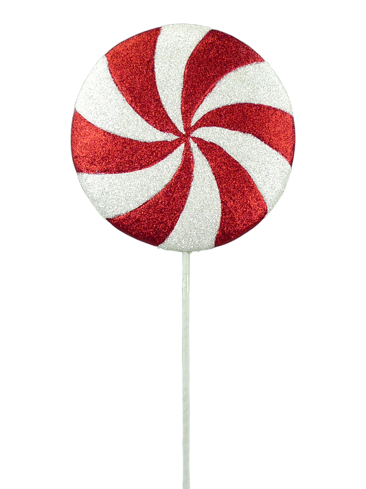 a large, red and white candy-like object with a spiral pattern on it.